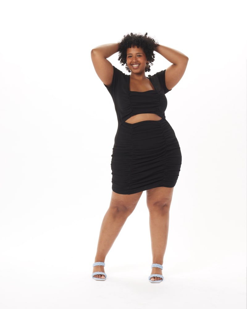 Front of a model wearing a size 2X Christian Ruched Cut-Out Dress in Black in Black by What Lo Wants. | dia_product_style_image_id:237932